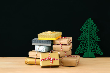 image of handmade wrapped gift boxes over wooden table.