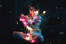 Happy Woman Wearing Glowing Jacket With Sequins Is Holding Light Balls In Her Hands
