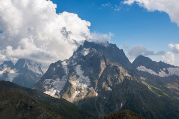 Closeup view mountains scenes in national park Dombai, Caucasus, Russia, Europe. Summer landscape, sunshine weather, dramatic blue sky and sunny day