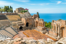 Ruins Of The Ancient Greek Theater In Taormina On A Sunny Summer Day With The Mediterranean Sea. Province Of Messina, Sicily, Southern Italy.
