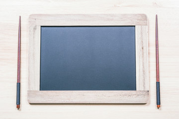 Blackboard With Wooden Frame And Copy Space For A Menu Next To Two Chopsticks