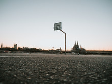 Urban Basketball Hoop With Skyline Of Cologne, Germany, In Background