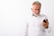 © Ranta Images - Studio shot of angry senior bearded man using mobile phone