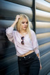 © mr2853 - Photographing a girl during autumn near a high-tech glass building with a blurred background of the park