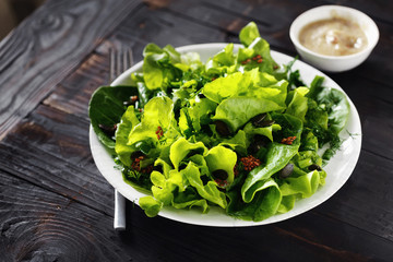 Wall Mural - Bowl fresh green lettuce various lettuce leaves wooden table