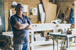© Peruphotoart - Portrait of senior carpenter. Standing in his workshop and looking at camera.