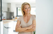 © goodluz - 40-year-old blond woman standing inside house