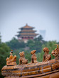 sculpture with Jingshan Park temple in background in Beijing