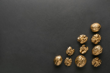 Wall Mural - Golden walnuts on black background