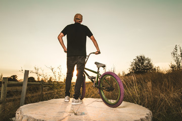 Wall Mural - BMX rider at sunset. Guy riding a bmx bike