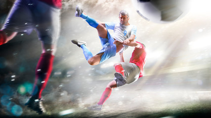 Soccer players in action on the grand stadium background panorama