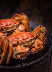 Two cooked hairy crabs on the table.