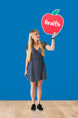 Wall Mural - Cheerful woman holding a healthy apple icon