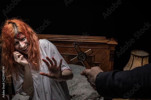 Cuadros en Lienzo Scary woman possessed by devil in the bed. Exorcism of priest.