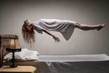 woman levitating over bed / astral traveling, nightmare, excorcist halloween concept