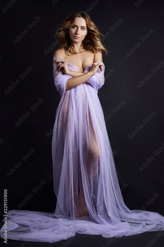 Naked woman art in lilac light transparent dress posing on a dark  background. Woman wrapped in purple fabric, beautiful slim figure, purity  and integrity. Luxurious Nude naked woman Stock Photo | Adobe