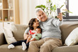 © Syda Productions - family, fatherhood and people concept - happy father with preteen and baby son taking selfie at home