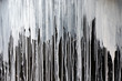© troyka - Drips of white paint on black wall.