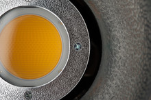 Close-up - Yellow Diffusing Filter Part Of Studio Illuminator With Four Screws On The Iron Part. Studio Equipment Concept