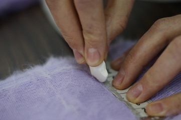 Dressmaker cutter. Clothing designer. Process.