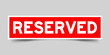 Red color sticker in word reserved on gray background