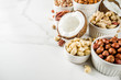 © ricka_kinamoto - Various types of nuts - walnuts, pecans, peanuts, hazelnuts, coconut, almonds, cashews, in bowls