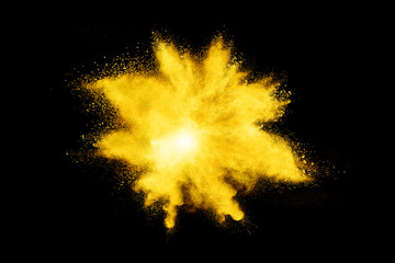 Wall Mural - yellow powder explosion on black background.
