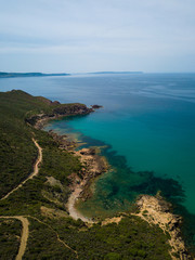 Beach landscape. Emerald green sea water and rocks on coast of Sardinia, Italy.