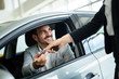 © NDABCREATIVITY - Professional salesperson during work with customer at car dealership.