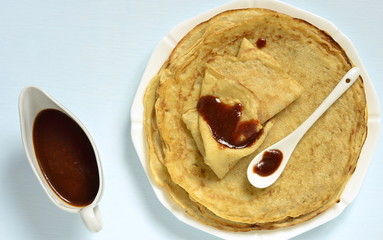 Wall Mural - Pancakes crepes with caramel sauce, top view, copy space