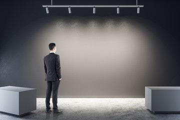 Poster - Businessman in illuminated gallery