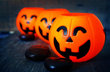 Three pumpkins smile decorate on wood background for halloween night