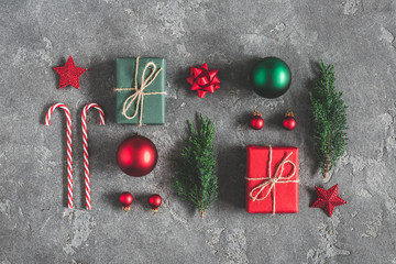 Christmas composition. Gifts, fir tree branches, red decorations on black background. Christmas, winter, new year concept. Flat lay, top view, copy space