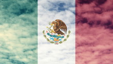 Mexican Flag With Cloud Sky Background.