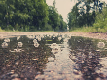Puddle With Bubbles On The Road During The Rain