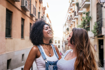 Wall Mural - Beautiful women having fun in the street.