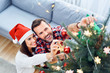 © baranq - Portrait of joyful couple decorating christmas tree and spending time together during holiday
