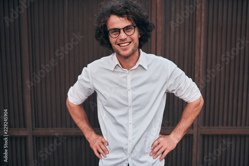 Outdoor Shot Of Smilimg Handsome Young Businessman With Glasses