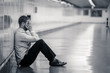 © SB Arts Media - Young businessman crying abandoned lost in depression sitting on ground subway