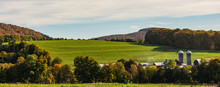 Smoke Rising From Farm House In Fall With Fields Surrounded By Woods In Bright Autumn Colors Of Fall Foliage