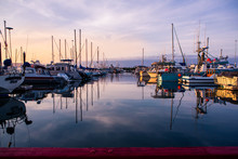 Sunset At Marina With Boats Docked On Water In Alaska