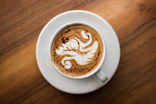 Overhead View Of Coffee Cup With Latte Art On Table