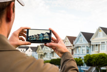 Man Using A Phone's Camera App To Photograph Homes In San Franci