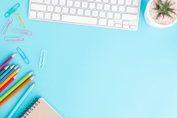 Wall Mural - flat lay photo of office desk with pencil and keyboard ,top view workpace on blue background and cop