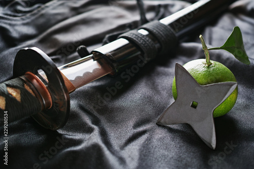 黒い布の上の抜きかけた日本刀と手裏剣とミカン Buy This Stock Photo And Explore Similar Images At Adobe Stock Adobe Stock