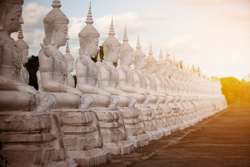 Wall Mural - Row white buddha statue with sun light