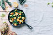 © Nata_a Mandi_/Stocksy - Sauteed veggies in a iron pan