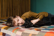 © Rebecca Spencer/Stocksy - Young pet owner together with his puppy at home