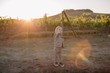 © Liliya Rodnikova/Stocksy - Lovely little boy standing by the vineyard in sunset light