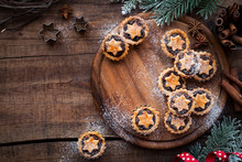 Christmas Mince Pies  On Wooden Cutting Board With Anise And Cinnamon Stick And Festive Xmas Decorations. Overhead View